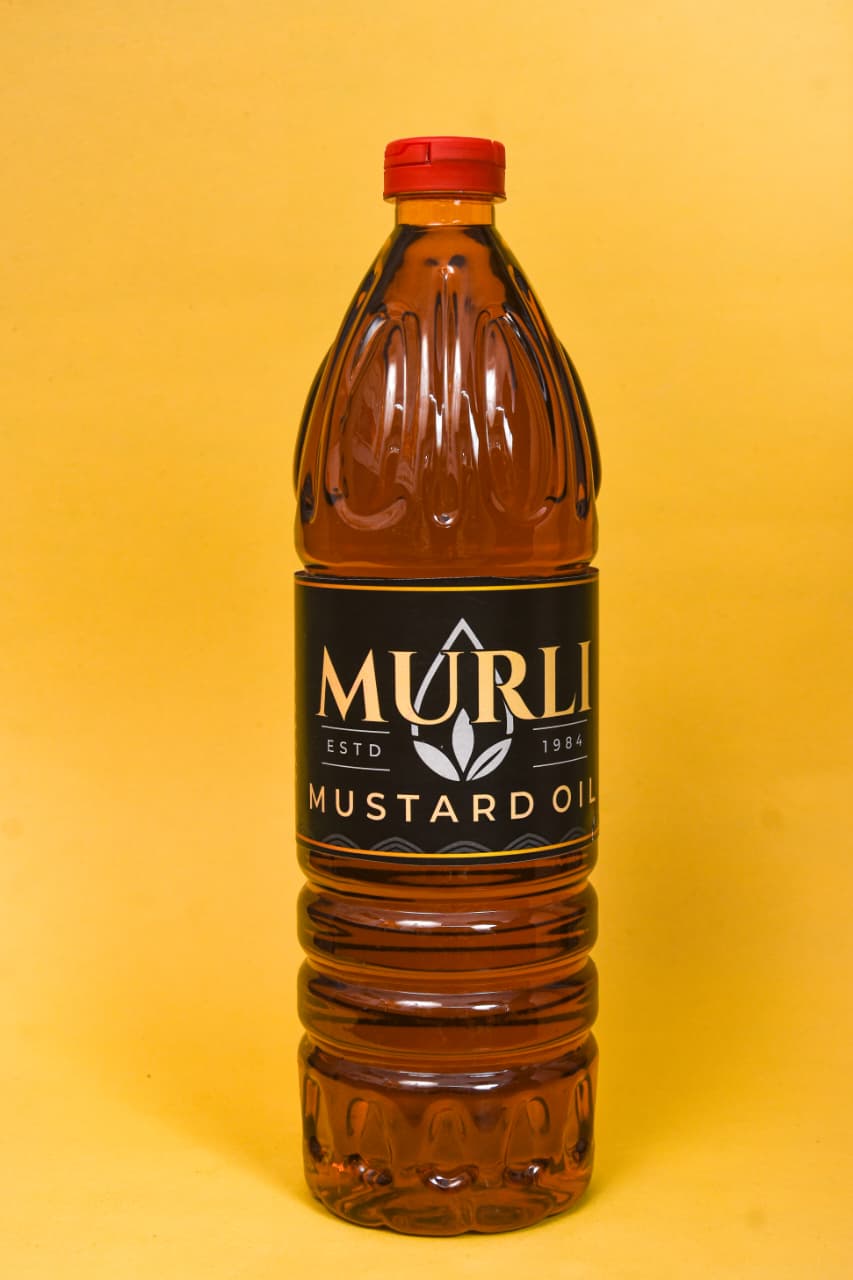 Murli Mustard Oil bottle with red cap, golden liquid, against yellow background